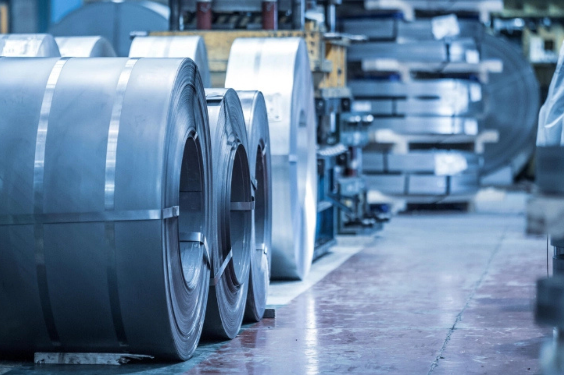Roll of black industrial rubber sheet on a cutting table in a warehouse
