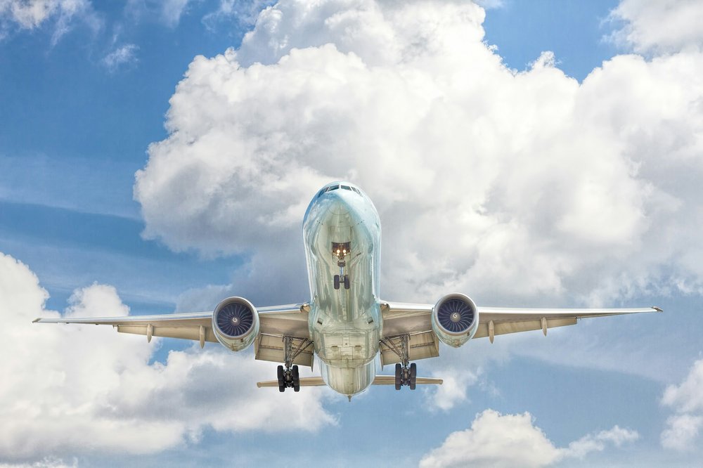 Commercial airplane in flight against blue sky