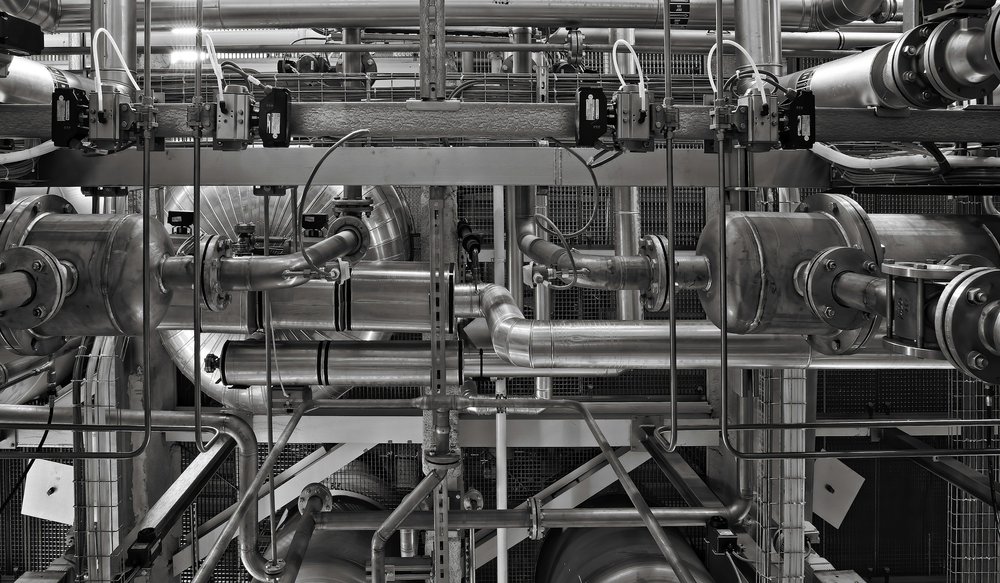 Network of stainless steel pipes, valves and industrial machinery